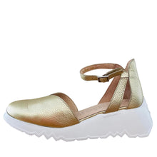 Load image into Gallery viewer, Gold wedge shoe with white sole on a wooden surface
