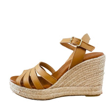 Load image into Gallery viewer, Tan wedge sandal with espadrille sole on a wooden surface
