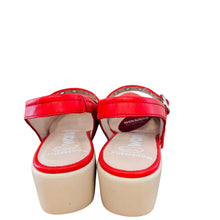 Load image into Gallery viewer, Red sandals with white soles on a wooden surface
