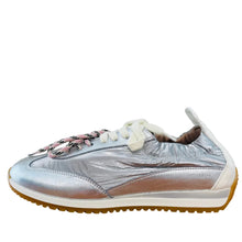 Load image into Gallery viewer, Silver sneaker with white laces on a wooden floor against a light gray wall
