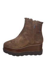Load image into Gallery viewer, A brown suede platform ankle boot with a ruffled elastic top, shown on a wooden table against a plain wall.
