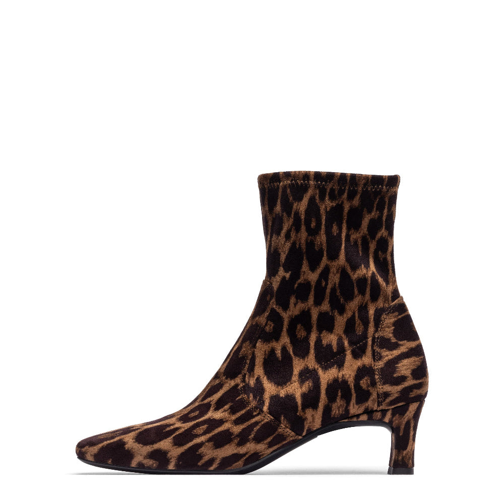 A leopard print ankle boot with a pointed toe and a low block heel, shown from a side profile on a white background.