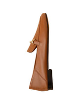 Load image into Gallery viewer, Brown leather loafer with a decorative buckle on a beige background
