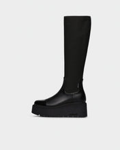 Load image into Gallery viewer, A single black knee-high boot with a chunky platform sole, shown in profile against a light gray background.
