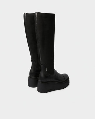 A single black knee-high boot with a chunky platform sole, shown in profile against a light gray background.