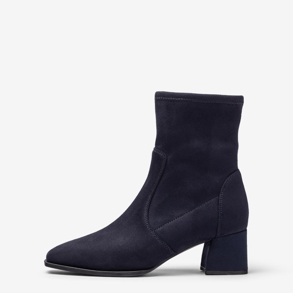 A single navy blue ankle boot with a block heel and pointed toe, shown in a side profile on a light gray background.
