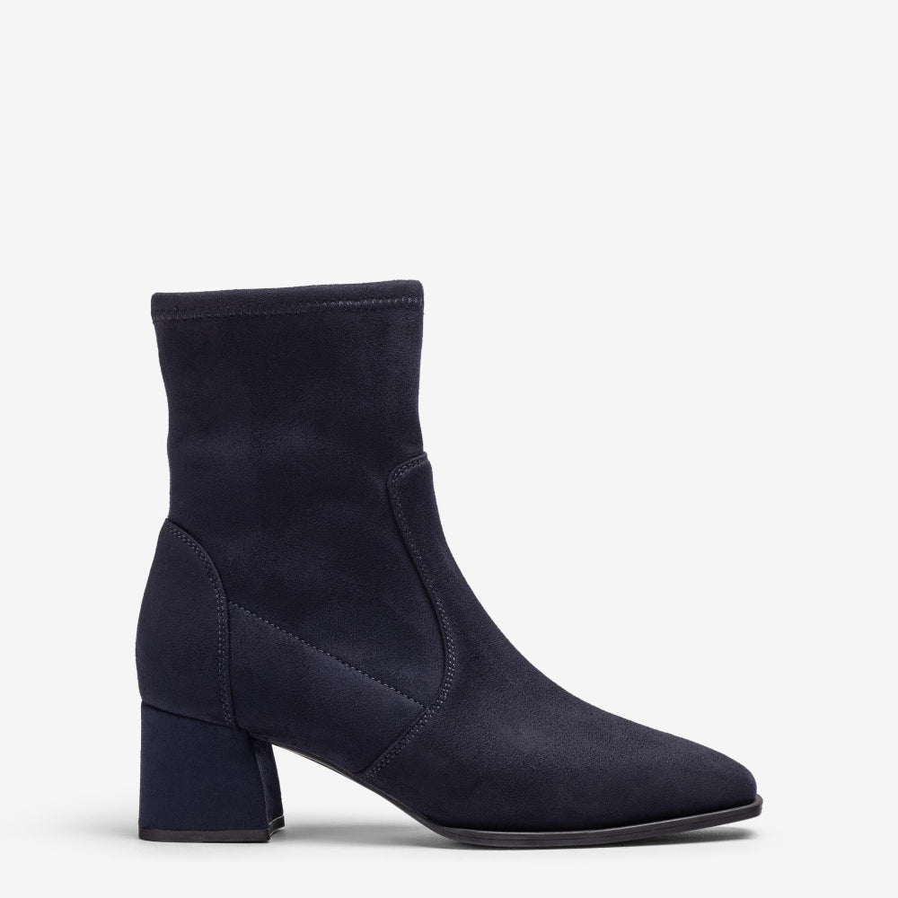 A single navy blue ankle boot with a block heel and pointed toe, shown in a side profile on a light gray background.