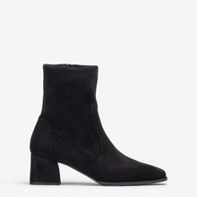 Load image into Gallery viewer, A black suede ankle boot with a block heel and pointed toe, shown in profile against a light gray background.
