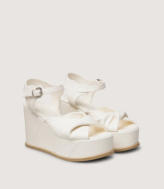 White wedge sandal on a light gray background