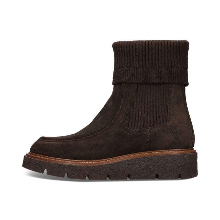 A dark brown ankle boot with a ribbed knit elastic side panel and a chunky lug sole, shown from a side profile on a white background.