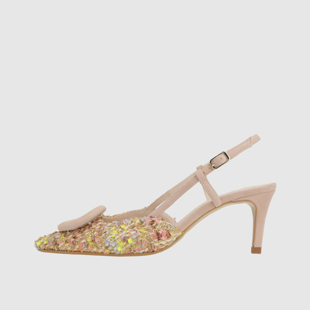 Beige high-heeled shoe with colorful sequins on a light gray background