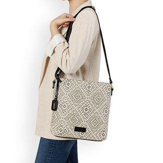 Person holding a patterned bag with a plain background