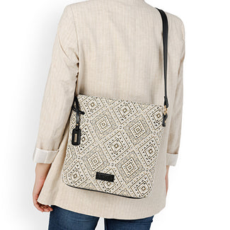 Person holding a patterned bag with a plain background