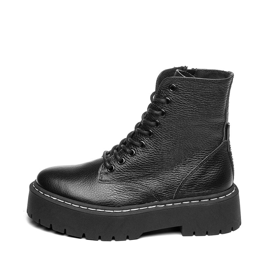 Black leather boot with a platform sole on a white background