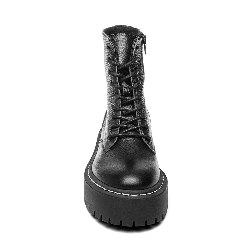 Black leather boot with platform sole on a white background