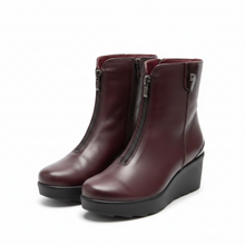Load image into Gallery viewer, A pair of women's ankle boots in burgundy leather with black wedge soles and side zippers, shown against a plain off-white background.
