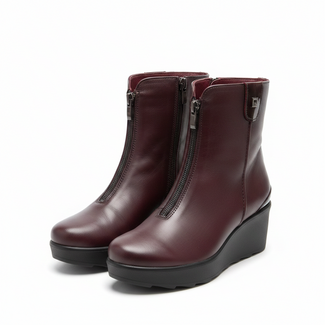 A pair of women's ankle boots in burgundy leather with black wedge soles and side zippers, shown against a plain off-white background.