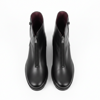 A pair of black leather ankle boots with wedge heels and side zippers, photographed on a plain light background.