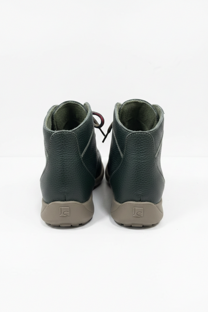 A pair of dark green leather high-top sneakers shown from the back, featuring a textured leather upper, dark green lining, and brown rubber soles with a visible 'JB' logo.