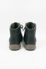 Load image into Gallery viewer, A pair of dark green leather high-top sneakers shown from the back, featuring a textured leather upper, dark green lining, and brown rubber soles with a visible 'JB' logo.
