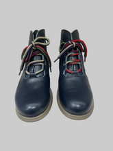Load image into Gallery viewer, A pair of dark navy blue leather ankle boots with distinctive red, green, and beige striped laces, shown from the front on a white surface against a light gray background.
