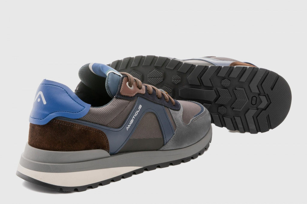 Gray and brown sneakers with blue accents on a light gray background