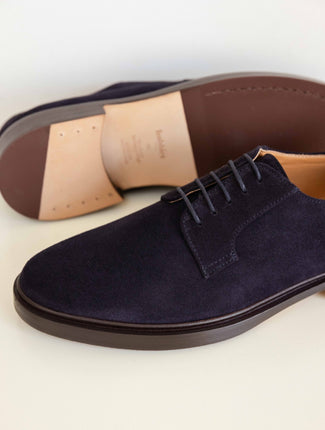 Navy suede shoe on a light background
