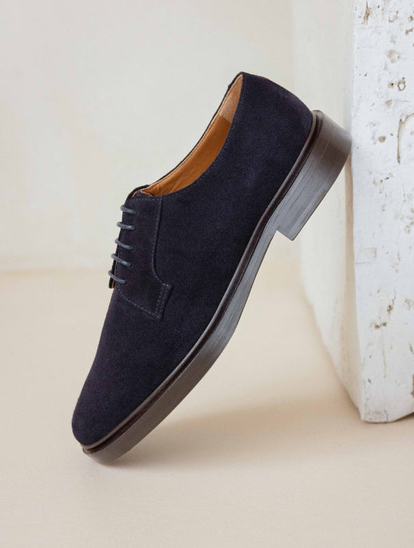 Navy suede shoe on a light background