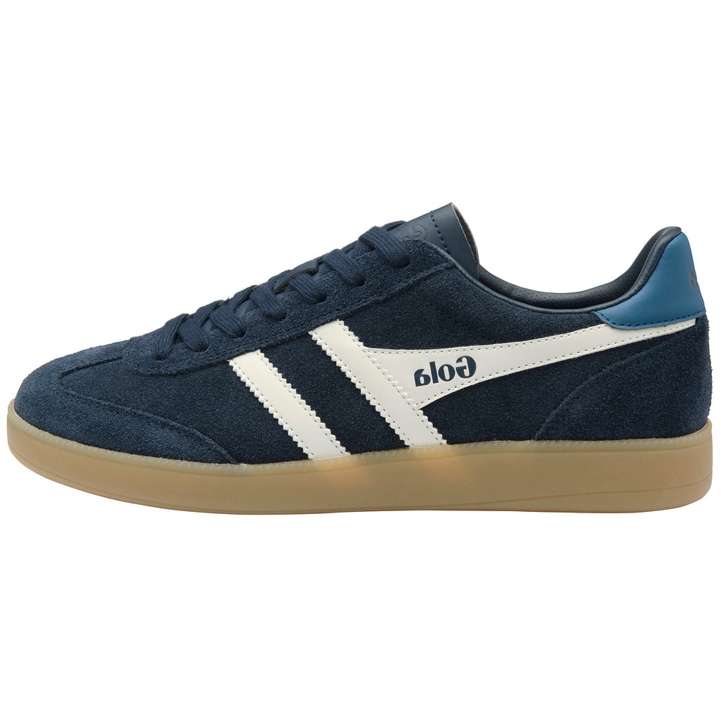A navy blue suede sneaker with white side stripes, a light blue heel tab, and a gum sole, shown in profile against a white background. The brand name 'Gola' is printed on the side.