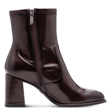 Load image into Gallery viewer, Burgundy patent leather ankle boot with a block heel on a transparent background
