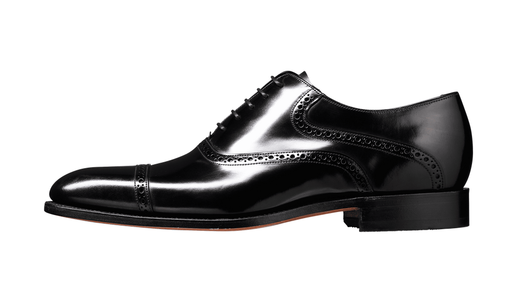 Shiny black dress shoe on a transparent background