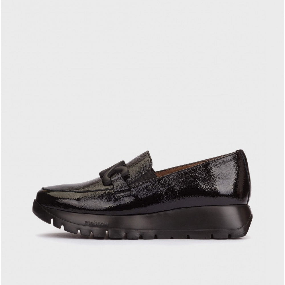 Black loafer shoe on a light gray background