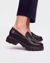 Load image into Gallery viewer, Wonders A4315 black leather fringe loafers with metal studs and a chunky sole, shown worn with dark trousers.
