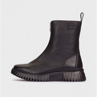 Black leather boot on a light gray background