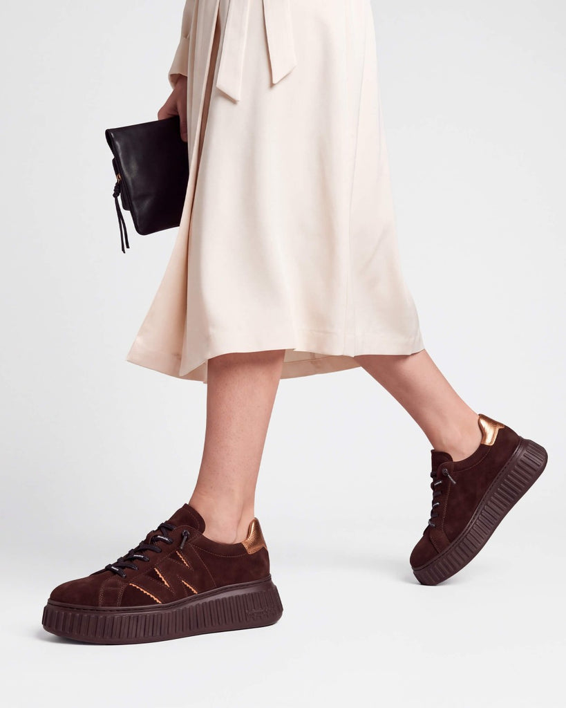 Wonders A5201 dark brown and gold platform trainers, shown worn with a cream skirt.