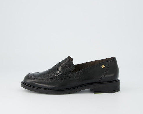 Black leather loafer shoe on a white background