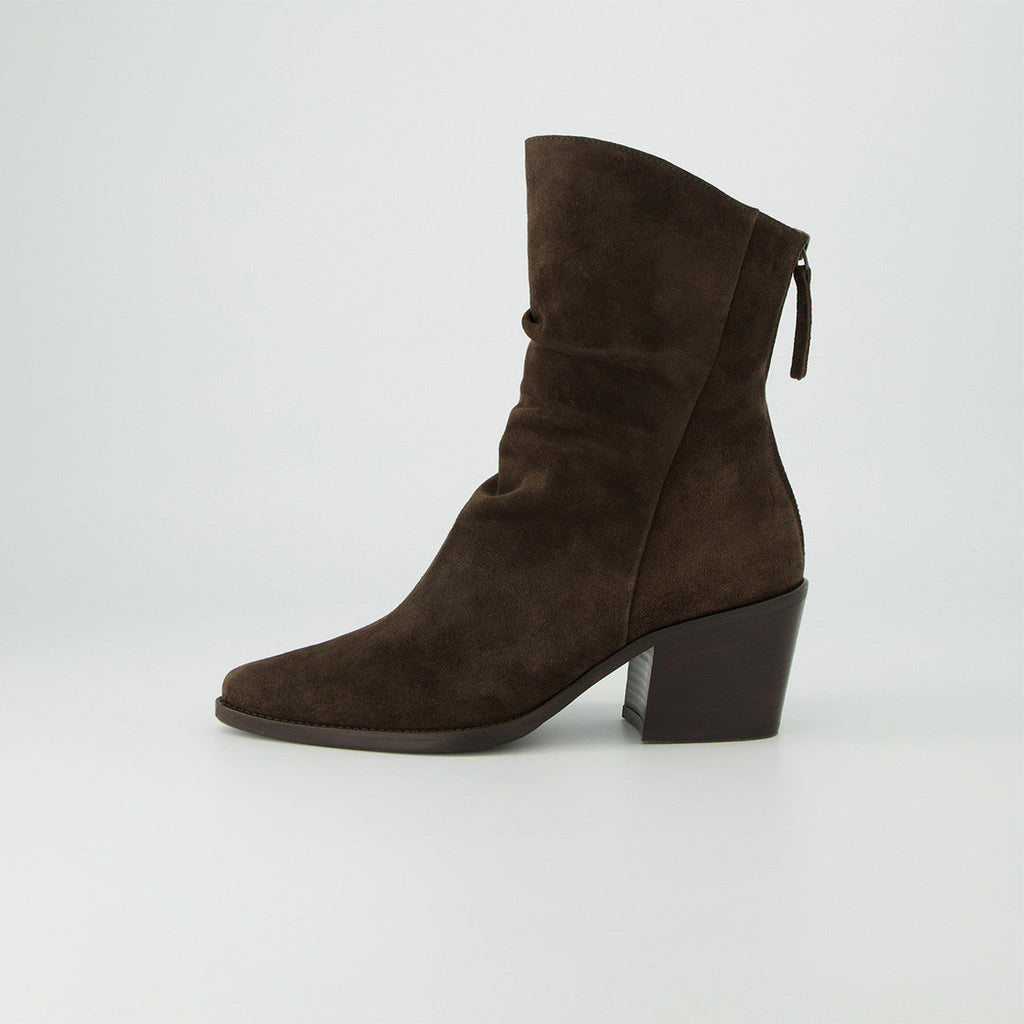 Brown suede ankle boot on a light gray background