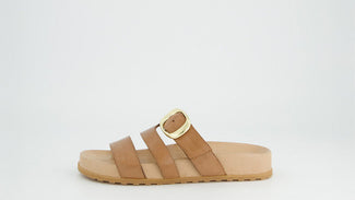 Tan sandal with a gold buckle on a white background