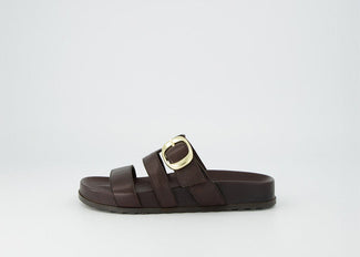 Brown sandal with a gold buckle on a white background