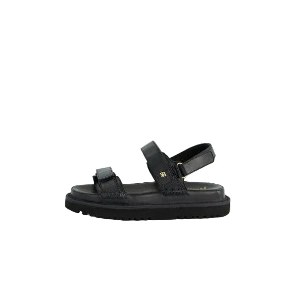 Black sandal with a strap on a light gray background