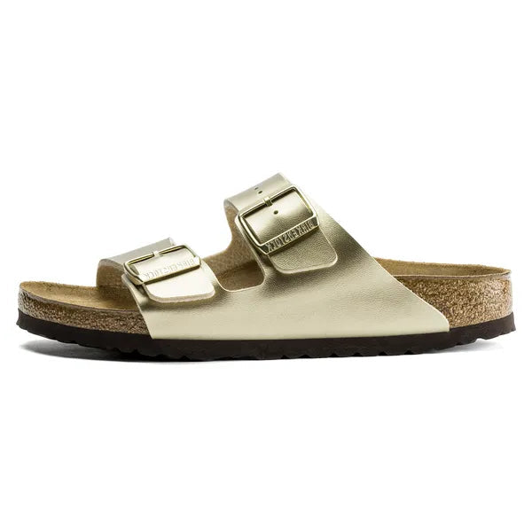 Gold sandal with a strap on a white background