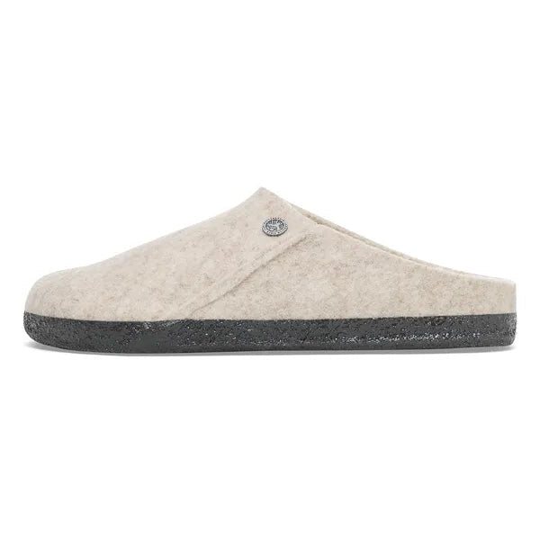 Beige slipper with a black sole on a white background