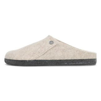 Beige slipper with a black sole on a white background