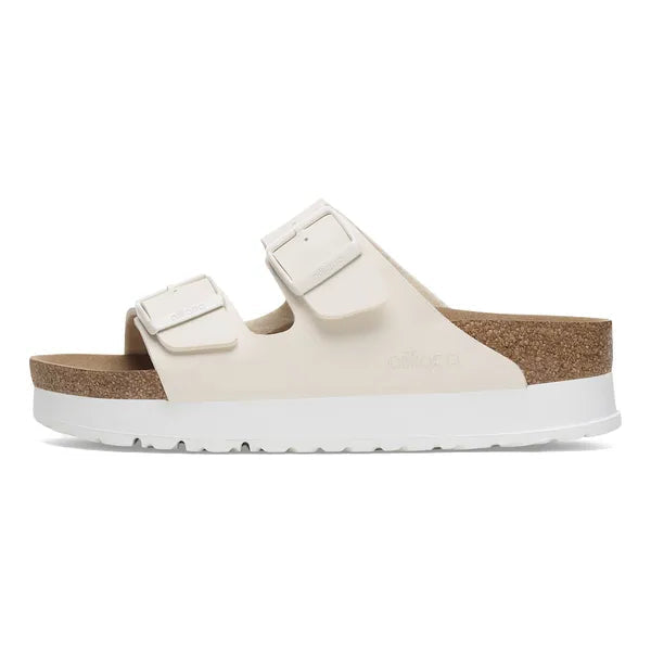 White sandal with cork sole on a white background