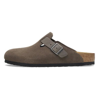 Brown suede clog shoe with a single buckle on a white background