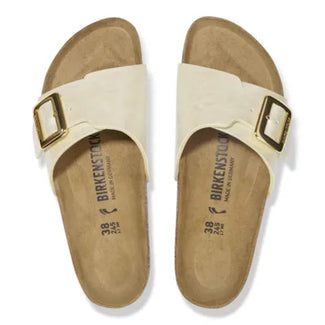 White sandal with gold buckle on a white background