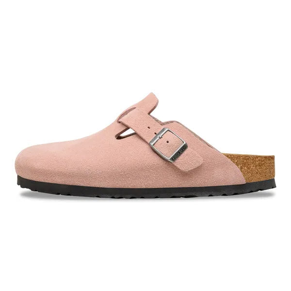 Pink clog shoe with a buckle on a white background