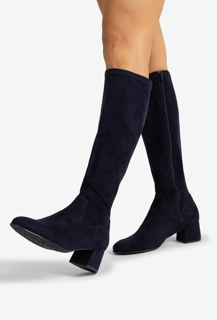 Navy knee-high boots on a white background