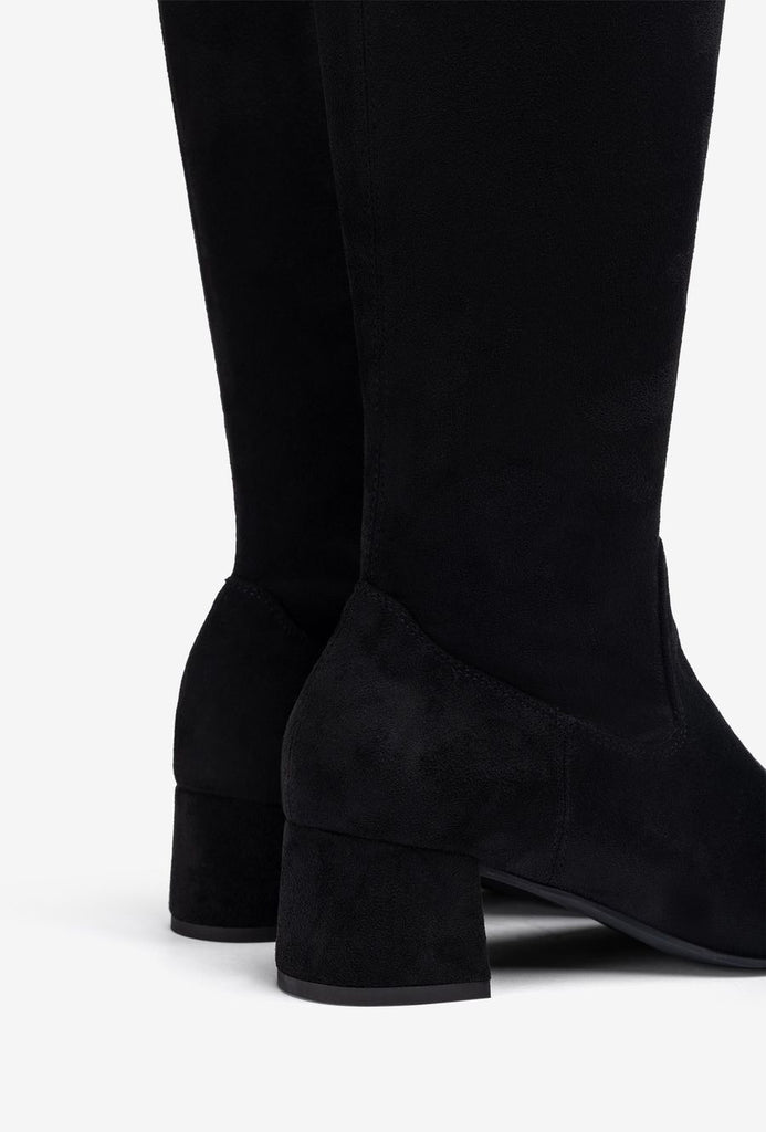 Black knee-high boots on a white background