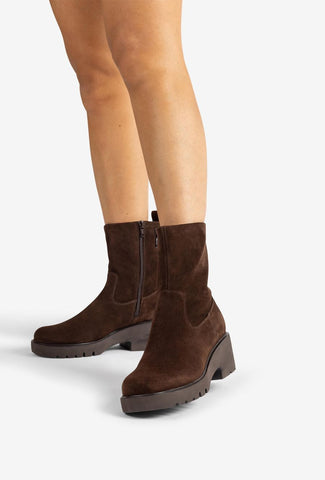 Brown suede boot on a white background